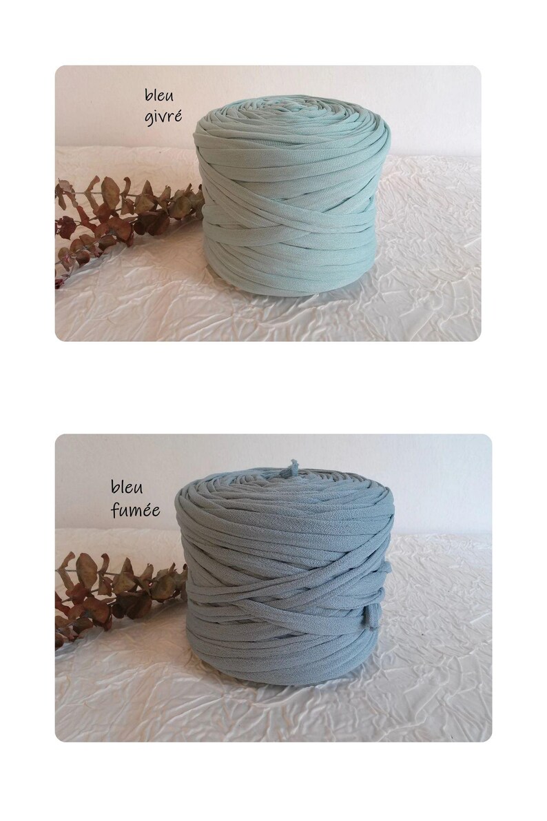 May include: Two spools of fabric yarn in shades of blue. The top spool is a light blue, and the bottom spool is a muted blue. The text "bleu givr&eacute;" and "bleu fum&eacute;e" are visible on the image. The yarn is arranged in a cylindrical shape.