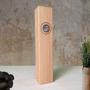 Könnte beinhalten: Eine hohe, rechteckige Holzkiste mit einem runden, durchsichtigen Glasfenster in der Mitte. Die Kiste ist aus hellbraunem Holz mit natürlicher Maserung.
