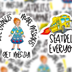 May include: Two colorful stickers featuring a cartoon character and a school bus. The first sticker features a woman with short brown hair wearing a blue dress with a colorful weather pattern. The text on the sticker reads "Take Chances Make Mistakes Get Messy!" The second sticker features a yellow school bus with a red rocket trail. The text on the sticker reads "Seatbelts, Everyone!"