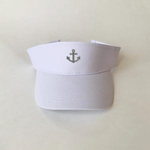 May include: White visor with an embroidered silver anchor on the front.