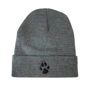 May include: Gray knit beanie with a black paw print embroidered on the front.