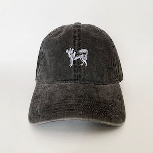 May include: A black, distressed, cotton baseball cap with an embroidered image of a white and gray husky dog.