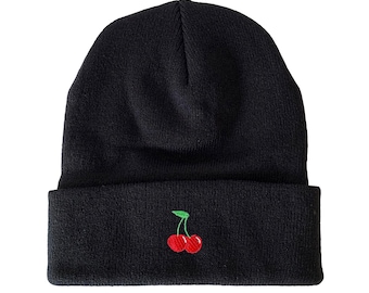 May include: A black beanie with a red cherry embroidered on the front.