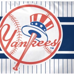 May include: A flag featuring the New York Yankees logo. The logo is a red and white baseball with the word "Yankees" in red script. A blue and white Uncle Sam hat and a baseball bat are in the center of the logo. The background has blue stripes and white pinstripes.