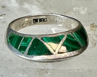 May include: A silver ring with a green malachite inlay. The ring is marked "CHIAPAS" on the inside.