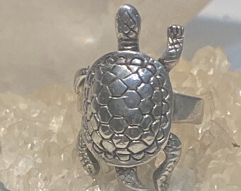 May include: A silver turtle ring with a detailed shell design. The turtle is standing on its hind legs with its front legs raised.