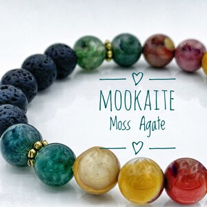 May include: A beaded bracelet featuring black lava rock, green moss agate, and multi-coloured Mookaite beads. The bracelet has gold spacers between the beads. The text "MOOKAITE Moss Agate" is written on a white background.