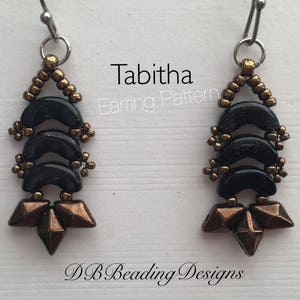 May include: A pair of black and gold earrings with a geometric design. The earrings are made with small beads and have a triangular shape at the bottom. The earrings are labelled "Tabitha Earring Pattern" and "DB Beading Designs".