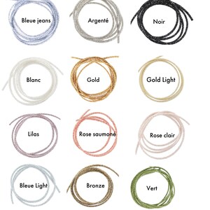May include: Twelve spools of glitter cord in various colors, including blue jeans, silver, black, white, gold, light gold, lilac, salmon, light pink, light blue, bronze, and green.