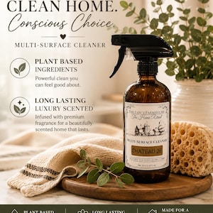 Puede incluir: Una botella de spray de vidrio marrón de limpiador multiusos The Fancy Farmhouse etiquetada como Chateau 26, con 473 ml. La etiqueta presenta una ilustración de una granja. El texto incluye Clean Home, Conscious Choice e ingredientes vegetales.