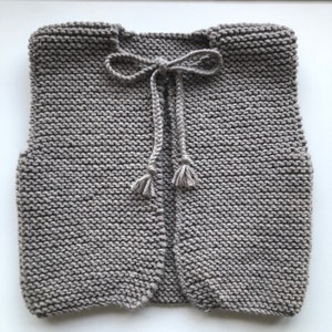 Hand knitted baby shepherd&#39;s vest in wool