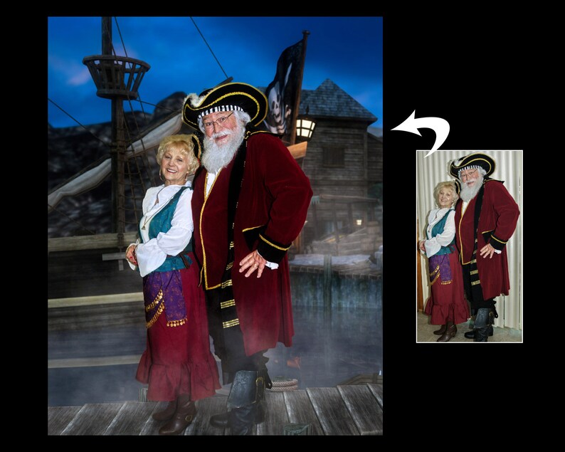 May include: A couple dressed as pirates, the woman in a red and teal dress and the man in a red coat with a black and white hat. They are standing in front of a ship and a wooden building.