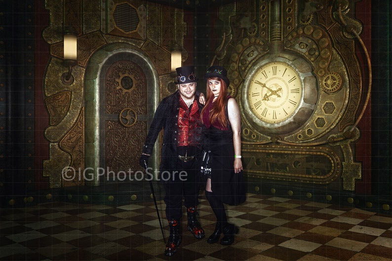 May include: A couple dressed in steampunk attire pose in front of a large clock and ornate door. The man wears a black jacket, red shirt, and top hat. The woman wears a black dress, top hat, and has long red hair.