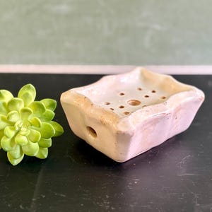 May include: A rustic wooden sign with the text "Welcome to our home" in white lettering. The sign features a distressed finish and a simple, inviting design, perfect for entryway decor.