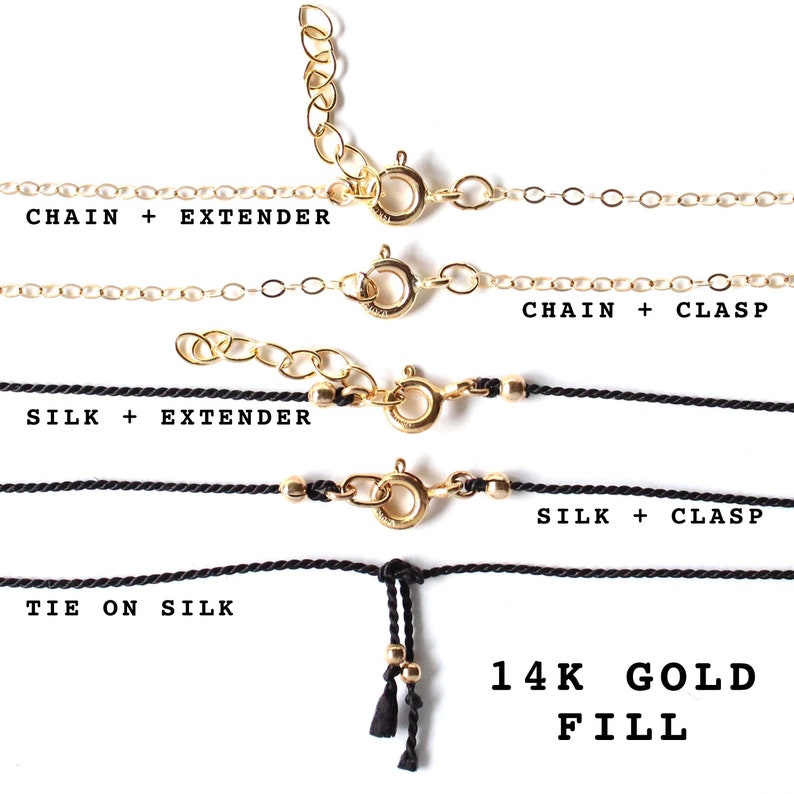 May include: Four different necklace styles are shown: a gold chain with an extender, a gold chain with a clasp, a black silk cord with an extender, and a black silk cord with a clasp. The last style is a black silk cord with a tie closure. All necklaces are made with 14k gold fill.