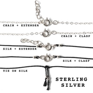 May include: A selection of sterling silver necklace chains and silk cords, each with different clasp and extender options. The image displays various necklace styles, including "Chain + Extender", "Chain + Clasp", "Silk + Extender", "Silk + Clasp", and "Tie on Silk".
