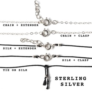 May include: Four different necklace styles with sterling silver clasps and extenders. The top two necklaces are silver chains, the bottom two are black silk cords. The text "CHAIN + EXTENDER", "SILK + EXTENDER", "TIE ON SILK", "CHAIN + CLASP", and "SILK + CLASP" labels each style. The text "STERLING SILVER" is at the bottom of the image.