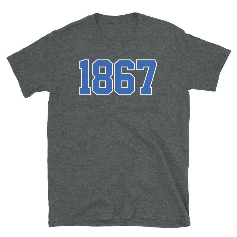 May include: A dark heather grey t-shirt with a blue and white number "1867" printed on the front.
