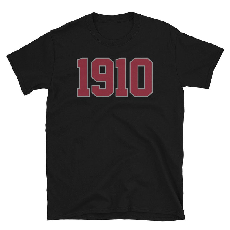 May include: Black t-shirt with a red 1910 printed on the front.