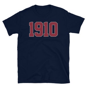 May include: A navy blue t-shirt with the number "1910" printed in red on the front.