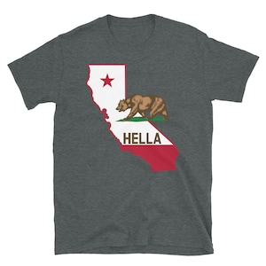 May include: A dark heather grey t-shirt with a graphic of the California state flag featuring a bear and the word "HELLA" printed on the red portion of the flag.