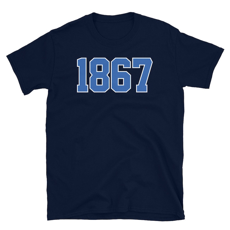 May include: Navy blue t-shirt with the number 1867 printed in white on the front.