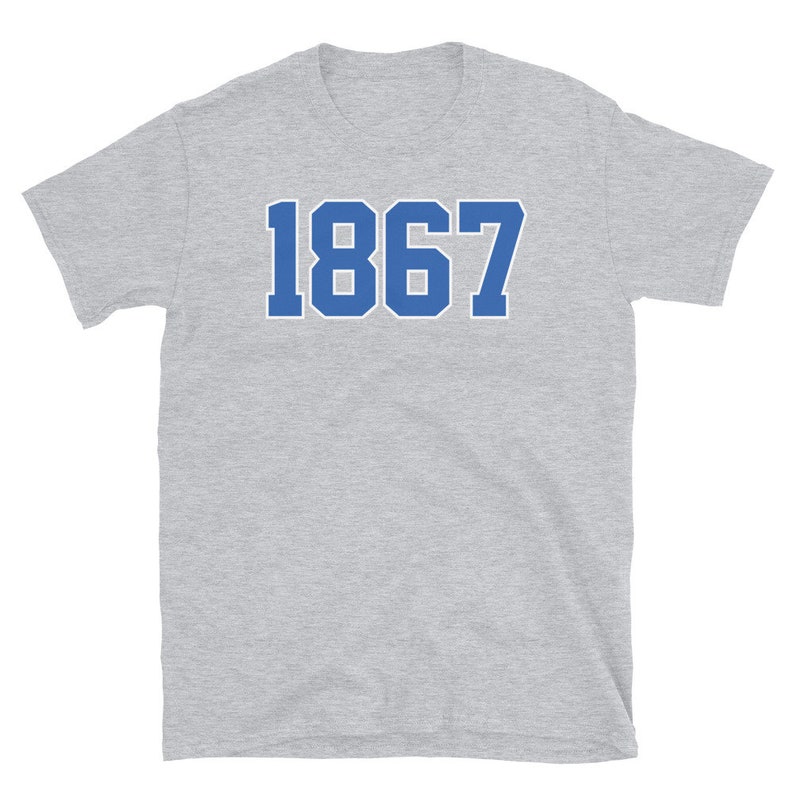 May include: A gray short-sleeved t-shirt with a blue number "1867" printed on the front.