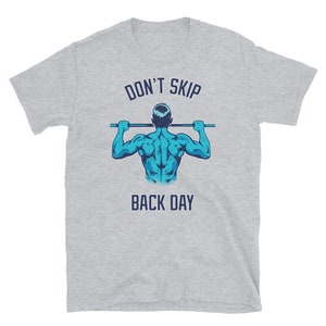 May include: Gray t-shirt with a blue illustration of a person doing a pull-up. The text "DON'T SKIP BACK DAY" is printed on the shirt.