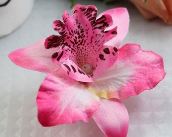 beautiful pink orchid mounted on crocodile clips