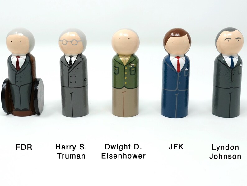 May include: Wooden peg dolls representing U.S. presidents: FDR, Harry S. Truman, Dwight D. Eisenhower, JFK, and Lyndon Johnson. Each doll is painted with details like suits, ties, and hair. FDR is in a wheelchair. Text labels identify each president.