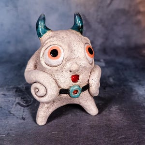 Baby Sploo-Chi Monster Figurine - Three Legged Ceramic Horned Creature With Spiral Arms, Teal Horns, Red Mouth