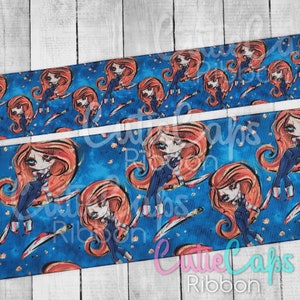 May include: Blue and red patterned ribbon with a repeating design of a cartoon girl holding a knife. The ribbon has a white background with a blue and red pattern.