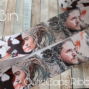 May include: White satin ribbon with a printed design of characters from the TV show Game of Thrones. The characters are Daenerys Targaryen and Jon Snow. The ribbon is 3 inches wide.