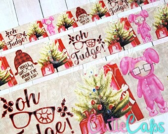 May include: A Christmas-themed ribbon with a beige background and red stripes. The ribbon features a Christmas tree, a pink bunny wearing glasses, and the text "Oh Fudge!" in red letters. The ribbon also includes the text "You'll shoot your eye out kid!" and "Oh Fudge!" in smaller text.