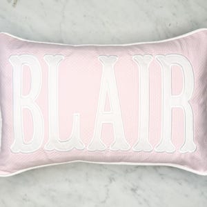 Boudoir Lumbar Name pillow(classic fishtail ) in pink Pique base fabric.many more styles at www.edelweissembroidery.com