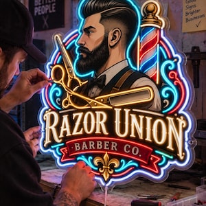 May include: A custom neon sign featuring a bearded barber in a suit, a barber pole, scissors, and a straight razor. The sign displays the text "RAZOR UNION BARBER CO." in a decorative font, illuminated with bright blue, red, and gold neon tubing.