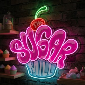 May include: A neon sign shaped like a cupcake with a cherry on top, featuring the text THE SUGAR MILL in bright pink and light blue. The sign glows against a dark brick wall, with small cupcakes displayed on wooden shelves nearby.