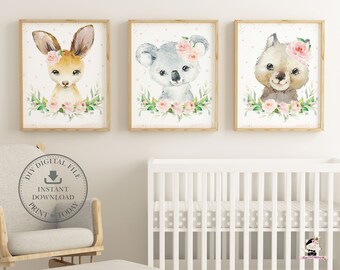 May include: Three watercolor prints featuring cute animal illustrations with floral accents. The prints feature a kangaroo, a koala, and a wombat. Each print has a white background with pink flowers and green leaves.