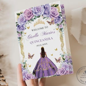 May include: Purple and gold Quinceañera invitation with a floral design and a crown. The text reads "Welcome to Giselle Marie's Quinceañera 06.25.20XX".