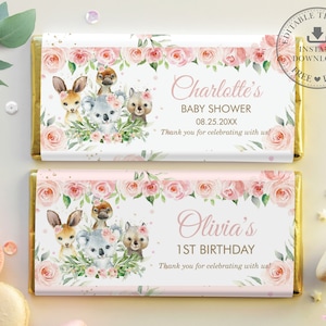 May include: Two pink and white chocolate bar wrappers with floral designs and gold accents. The top wrapper says "Charlotte's Baby Shower 08.25.20XX Thank you for celebrating with us!" The bottom wrapper says "Olivia's 1st Birthday Thank you for celebrating with us!" Both wrappers feature a watercolor illustration of a koala, a kangaroo, and a platypus.