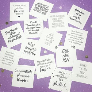 May include: A set of 12 motivational quote cards with a variety of positive messages. The cards are printed on white paper with black text and feature a variety of designs, including hearts, stars, and swirls.