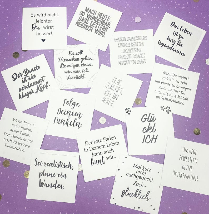 May include: A set of 12 motivational quote cards with a variety of positive messages. The cards are printed on white paper with black text and feature a variety of designs, including hearts, stars, and swirls.