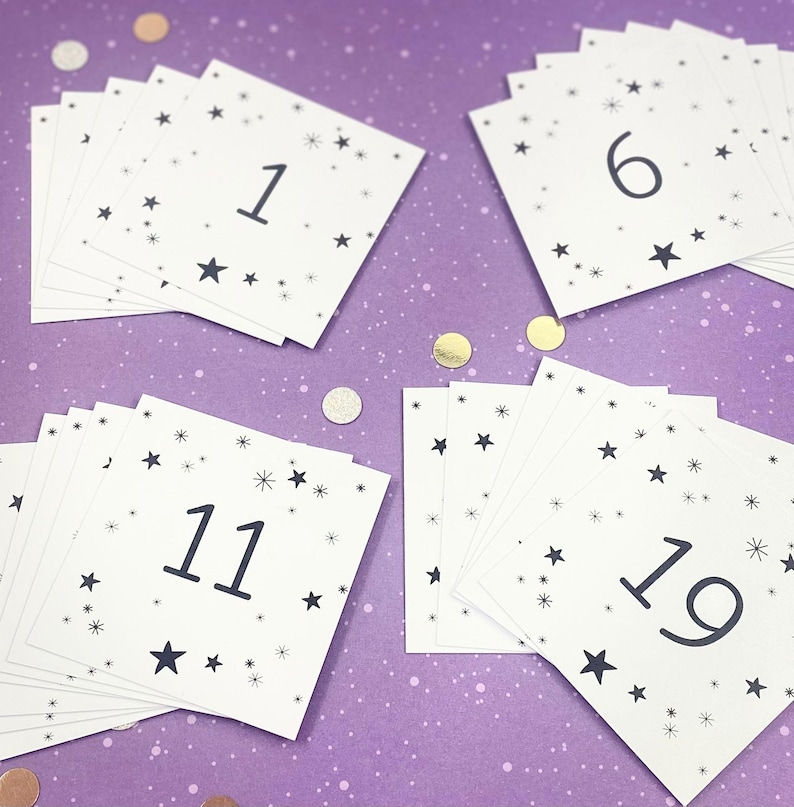 May include: A set of white cards with black numbers and stars printed on them. The numbers range from 1 to 19. The cards are on a purple background.