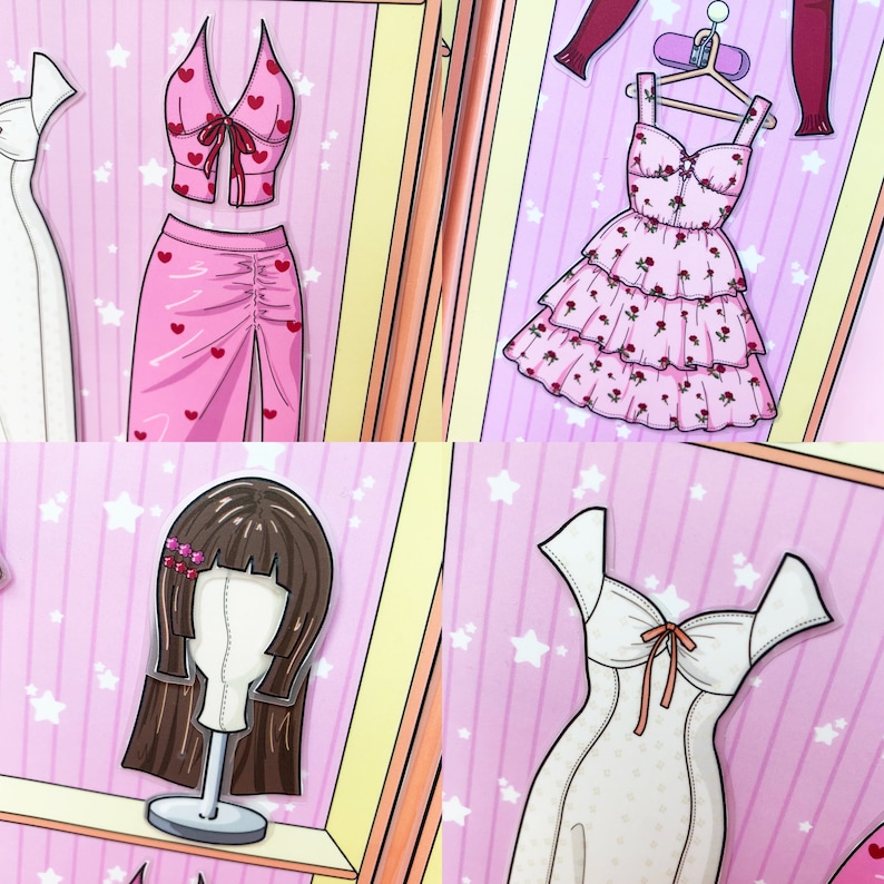 May include: A collection of paper doll clothing and accessories. Includes a pink two-piece outfit with heart accents, a tiered pink dress with rose patterns, a brown wig on a stand, and a white dress with a bow.