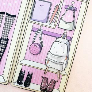May include: A pink and white closet with shelves and hangers. There are various items hanging on the hangers, including a backpack, a purse, and a round purse. There is a notebook on the top shelf with the word "Art" written on it. There are also shoes on the bottom shelf.