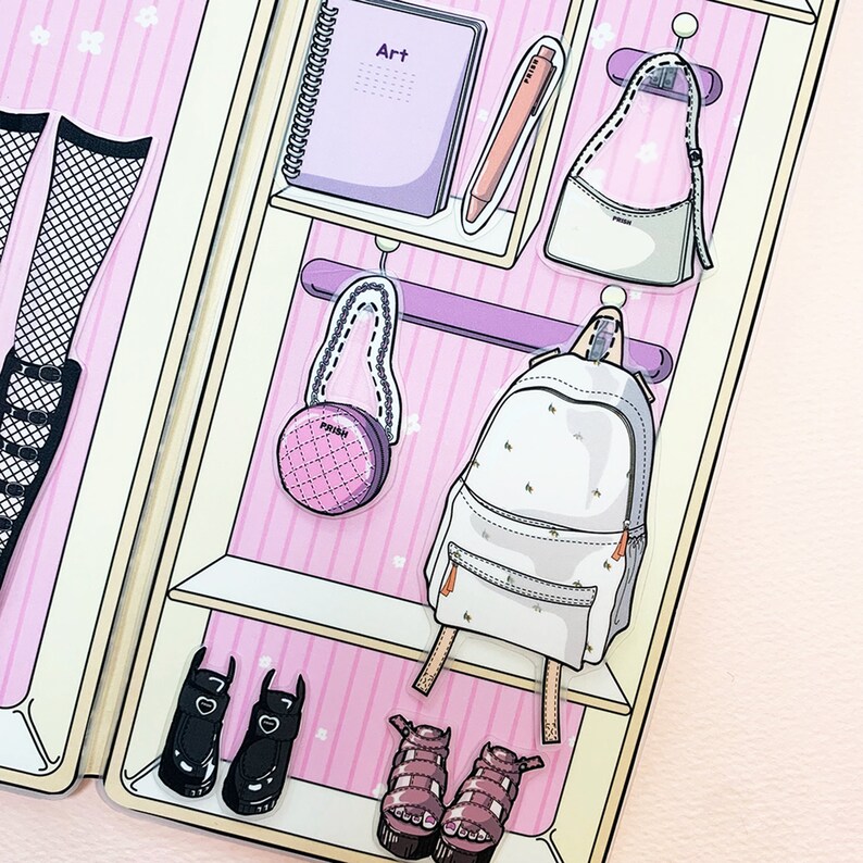 May include: A pink and white closet with shelves and hangers. There are various items hanging on the hangers, including a backpack, a purse, and a round purse. There is a notebook on the top shelf with the word "Art" written on it. There are also shoes on the bottom shelf.