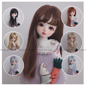 May include: A set of ten doll wigs in various colours, including black, brown, blonde, light blue, and orange. The wigs are styled with bangs and long, straight hair. The wigs are displayed on doll heads, each wearing a different outfit.