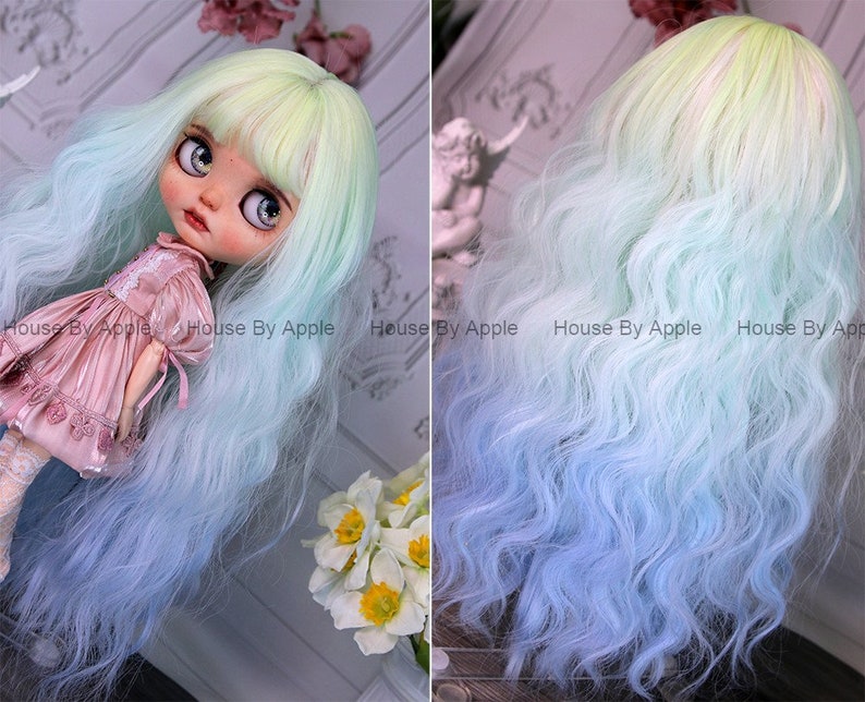 May include: A long, wavy doll wig with a light green to blue ombre color gradient. The wig is styled with bangs and has a natural, flowing texture.