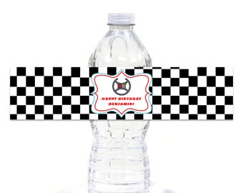 May include: Water bottle label with a checkered black and white background. The label has a red and blue frame with a steering wheel graphic and the text "Happy Birthday Benjamin!"