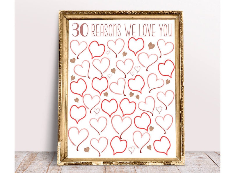 May include: A printable poster with a gold frame and the text "30 reasons we love you" in pink lettering. The poster is filled with pink and red hearts.